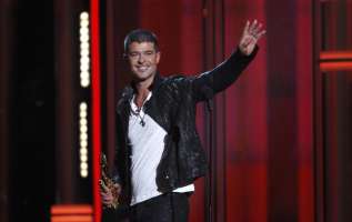 Singer Robin Thicke accepts the award for top R&B song for "Blurred Lines" onstage at the 2014 Billboard Music Awards in Las Vegas